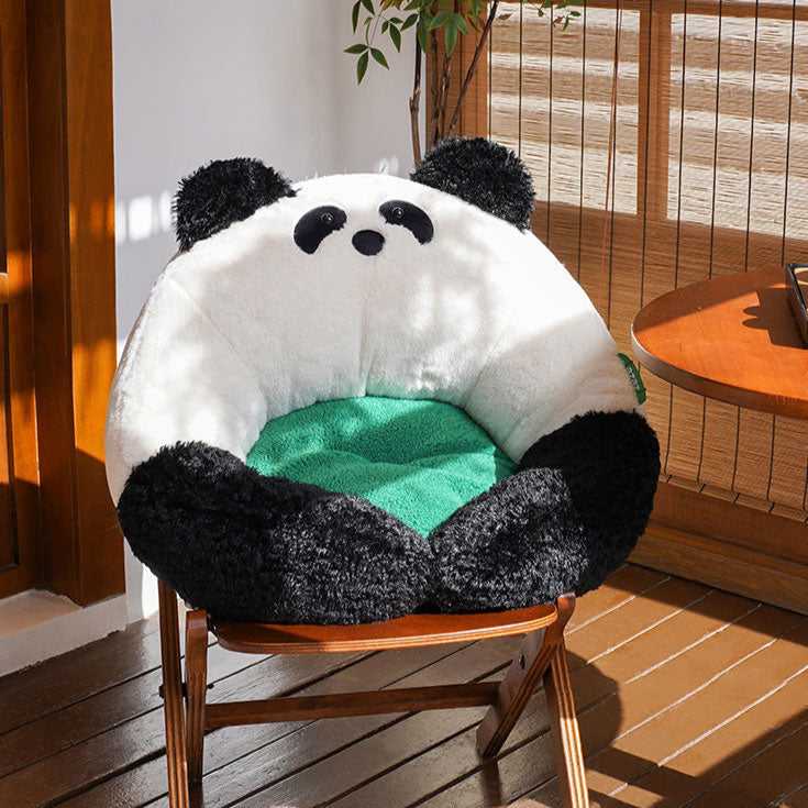 Panda Hug Cat Bed on a balcony chair, displaying its plush panda shape and green cushion for stylish and cozy cat furniture.