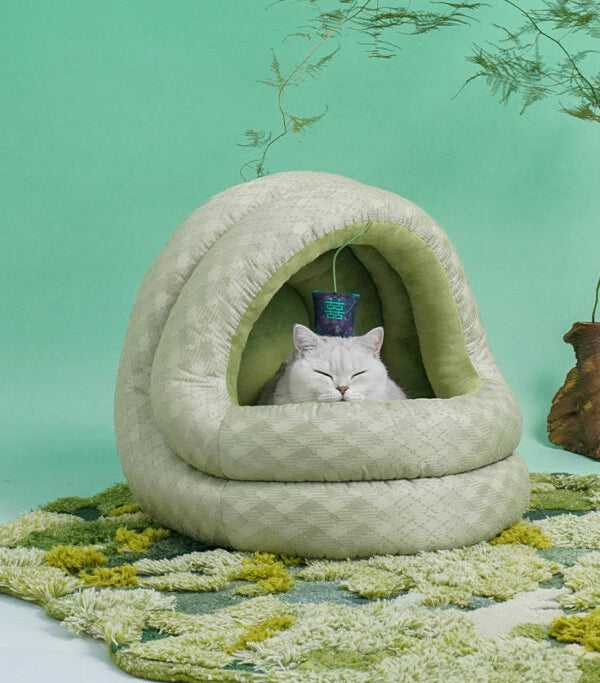 Green Pine Cave Cat Bed - Japanese Design on textured rug, featuring a relaxed cat and elegant dome structure for cozy sleep.