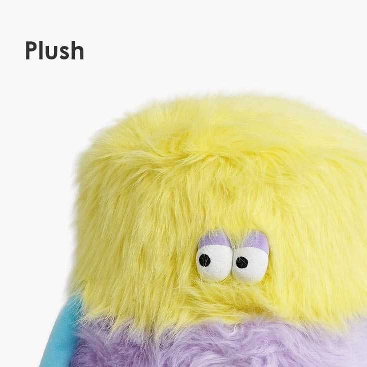 Close-up of the plush yellow top of the Little Monster Stool Cat Bed, emphasizing its soft and cozy material.
