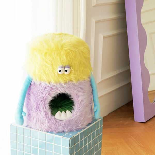 Little Monster Stool Cat Bed on a tiled pedestal near a mirror, featuring a wide monster mouth opening for cats to enter.