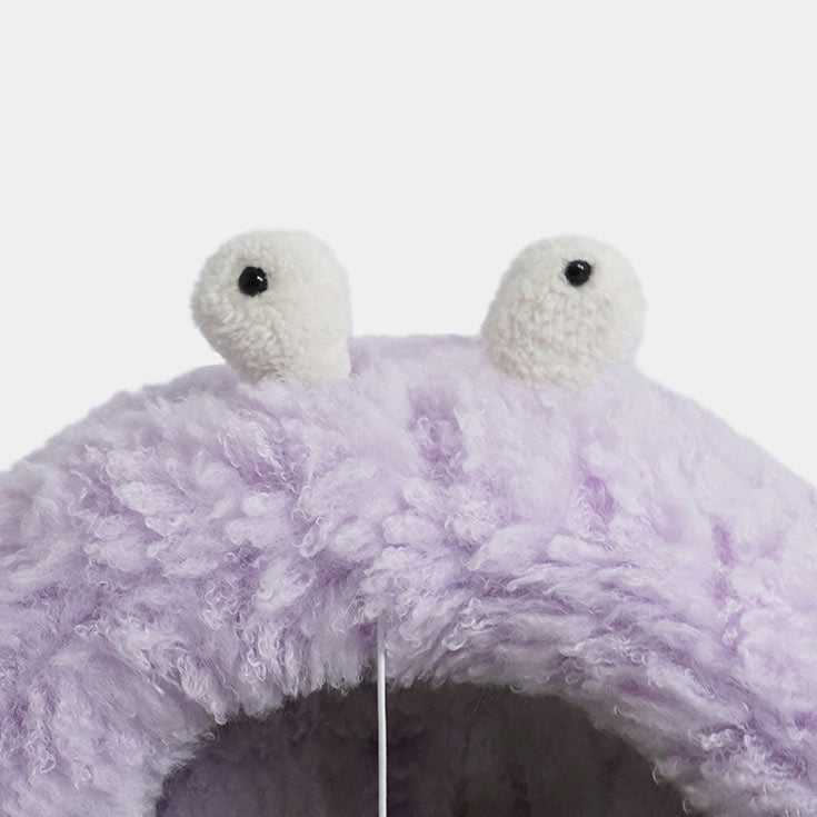 Close-up of purple Monster Series Cat Bed's plush monster eyes, emphasizing its cute and whimsical design details.