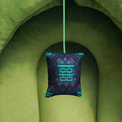 Close-up of hanging toy in Green Pine Cave Cat Bed - Japanese Design, adding interactive fun to cozy cat furniture.