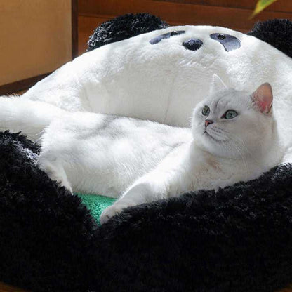 White cat lounging in the Panda Hug Cat Bed, showing the soft, panda-themed design ideal for cat comfort and support.
