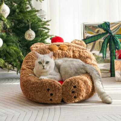 Cat curled in Apple Bear Hug Cat Bed with bear face and apple detail, perfect for holiday-themed pet decor.