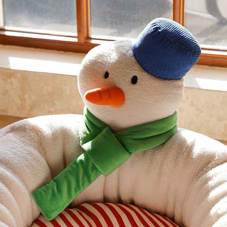 Detail view of snowman headrest on Hug Snowman Cat Bed with green scarf and blue hat, enhancing festive pet furniture appeal.