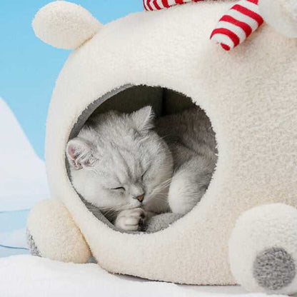 Sleeping cat nestled in Polar Bear Cat Bed - Cozy Winter Retreat, made of soft velvet and foam for heat retention during cold seasons.