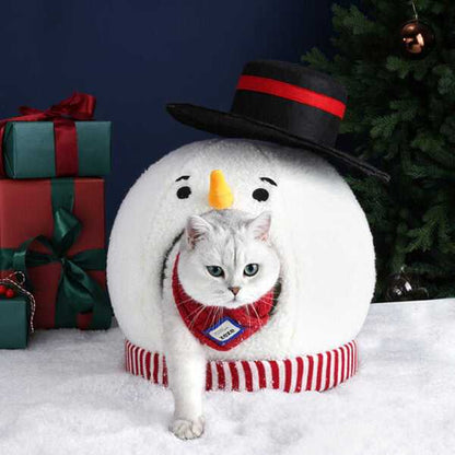 White cat stepping out of Snowman Cat Covered Bed, wearing red plaid harness, showcasing cozy pet bed design.
