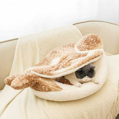 Gray cat nestled inside the Sparrow Cat Bed with foldable wings. Enclosed design offers warmth and security for cats.