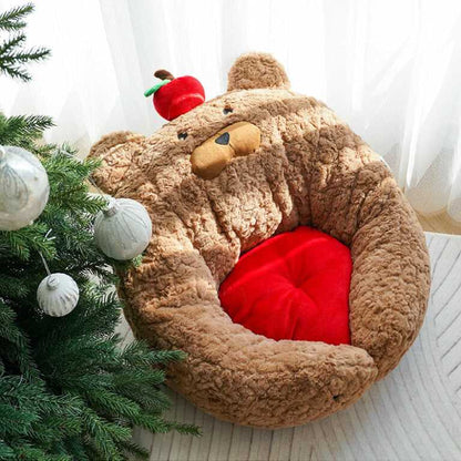 Top view of Apple Bear Hug Cat Bed near Christmas tree, showing plush bear design and vibrant red cushion.