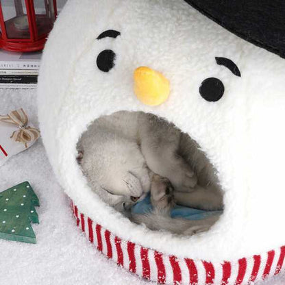 Cat sleeping curled inside Snowman Cat Covered Bed, highlighting soft interior and snug winter pet shelter.