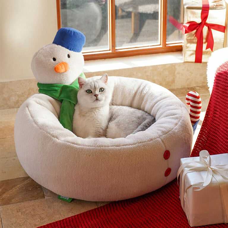 White cat lounging in Hug Snowman Cat Bed featuring festive snowman design, perfect for Christmas cat furniture collections.