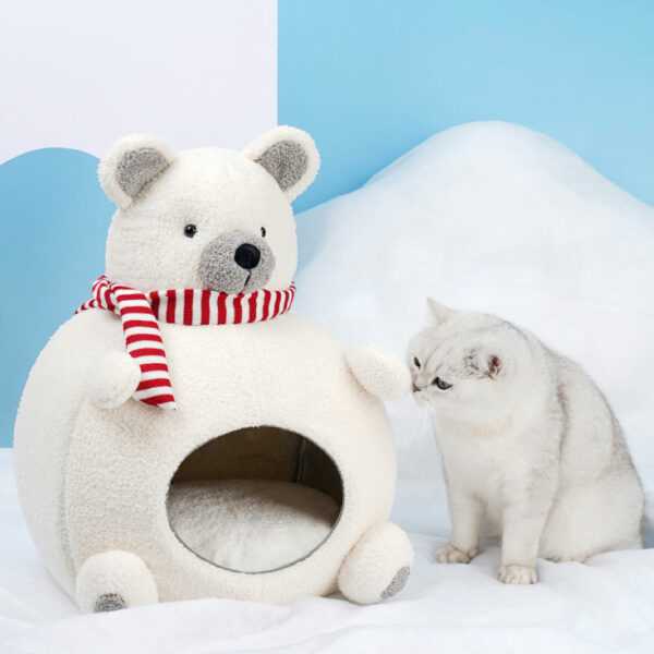 Curious cat exploring Polar Bear Cat Bed - Cozy Winter Retreat, a soft velvet hideaway with a cute bear design and red scarf.