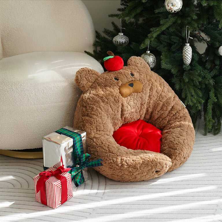 Apple Bear Hug Cat Bed placed near Christmas tree, showcasing its plush bear shape and red interior cushion.
