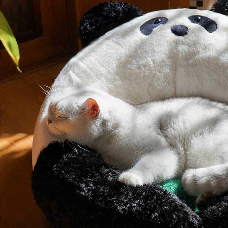 White cat sleeping peacefully in the Panda Hug Cat Bed, showing the soft, supportive panda design perfect for cat naps.