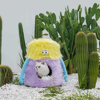 Little Monster Stool Cat Bed with a cat inside, placed among cacti. Unique cat furniture combining comfort and whimsical design.