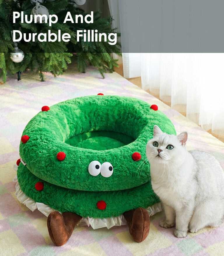 Cat beside Christmas Wreath Shaped Cat Bed with text 'Plump And Durable Filling' highlighting its supportive pet-friendly design.